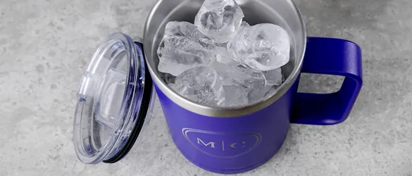 close up of ice in metal tumbler 