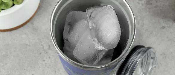 close up of ice in metal tumbler