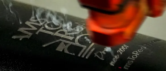 black metal tumbler being laser etched