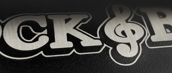 close up etching of black metal growler