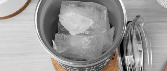 close up of ice in metal tumbler 