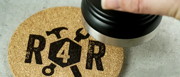 metal tumbler about to be set on cork coaster