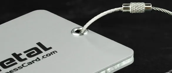 close up of metal luggage tag with metal tie