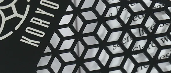 quick metal business cards chemically etched showing varying examples of cut out areas