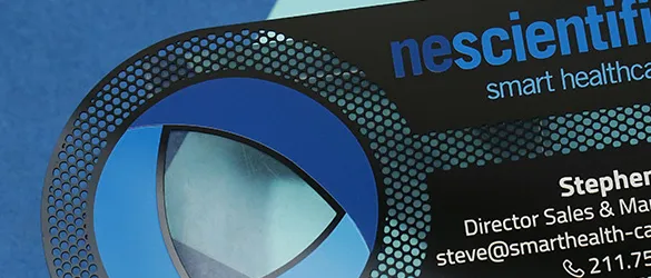 Close up of cut through areas on a black metal business card