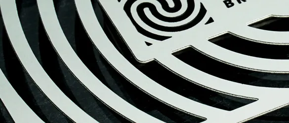 Stainless steel business card is chemically cut and etched