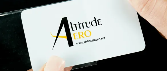 white metal business card wrapped in clear plastic sleeve for protection