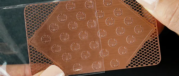 Copper finish metal business card in clear plastic sleeve for protection