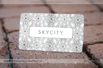 beautiful white metal business card with organic geometric pattern etched into surface