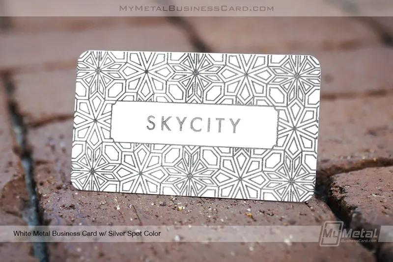 beautiful white metal business card with organic geometric pattern etched into surface