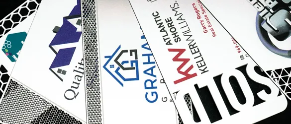quick metal business cards chemically etched showing varying examples of cut out areas