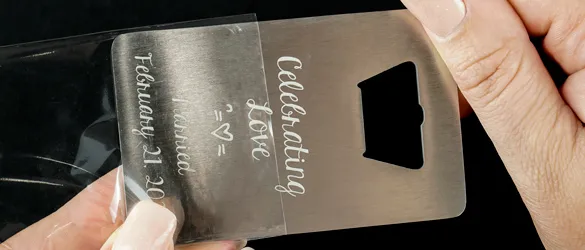 quick metal bottle opener sliding into clear plastic sleeve for protection