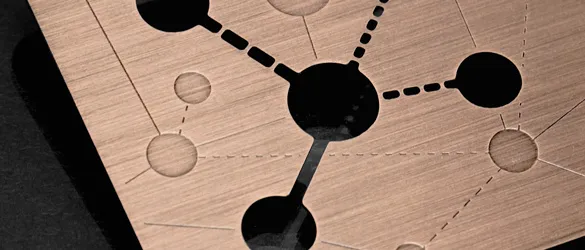 copper finish metal business card showing chemically cut-through and etched areas