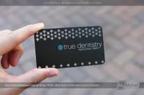 Black metal business card with blue screen printing and cut-out plus signs